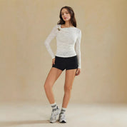 Nieuwe veelzijdige top met lange mouwen voor dames met een onregelmatig doorluidig ontwerp